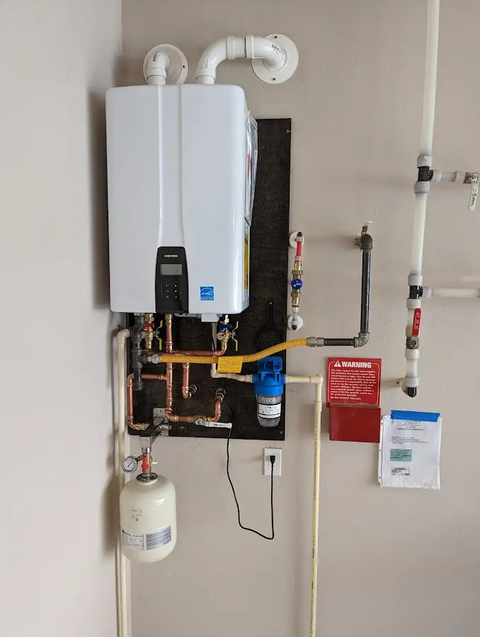 Professional plumber installing copper piping in a Corbin home